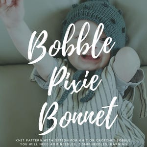 May include: A baby wearing a gray knit bobble pixie bonnet. The image features the text "Bobble Pixie Bonnet" and "Arlo Nursery". The baby is wearing a striped onesie. The pattern is available in sizes 0-6M, 6-12M, 12-24M, and 24-48M.
