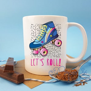 May include: White ceramic mug featuring a colourful illustration of a roller skate and the text "Let's Roll!"