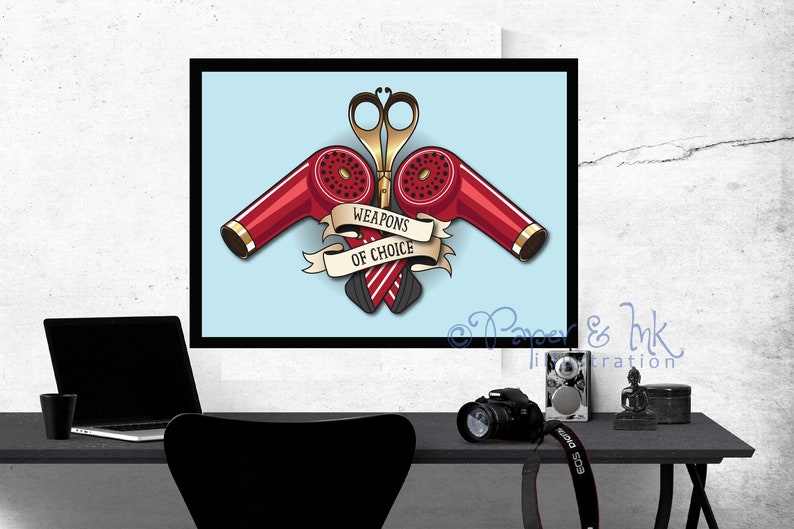 May include: A vintage-style illustration of two red hair dryers and a pair of scissors crossed over each other. The illustration is on a light blue background with a banner that reads "Weapons of Choice".