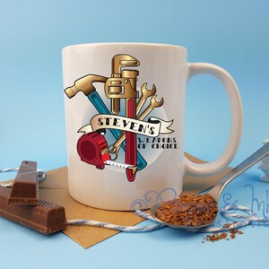 May include: White ceramic mug with a graphic of tools including a hammer, wrench, tape measure, and a screwdriver. The graphic is in a vintage style with red, blue, gold, and black colors. The text "Steven's Weapons of Choice" is on the mug.