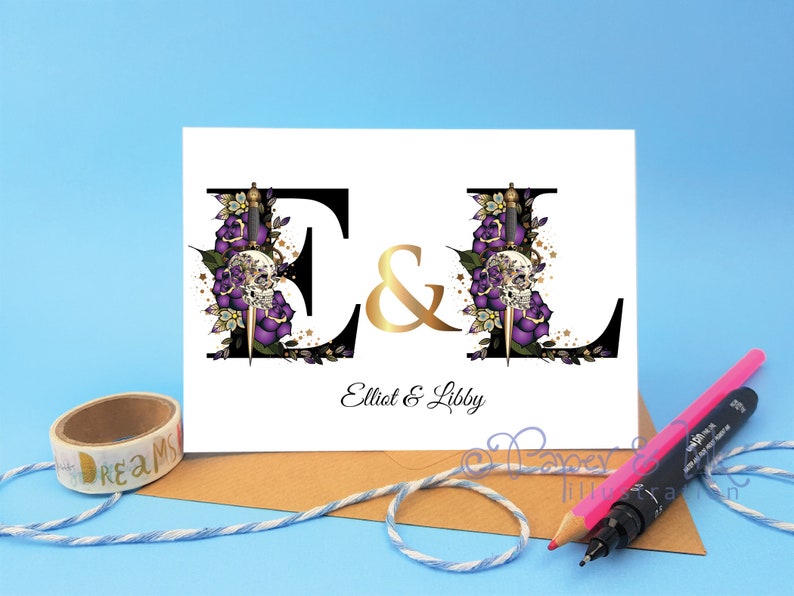 May include: A white card with black and gold lettering. The letters E and L are decorated with purple roses, skulls, and daggers. The text reads "E & L Elliot & Libby".