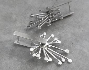 Kinetic latch back silver earrings.