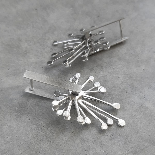 Kinetic latch back silver earrings.