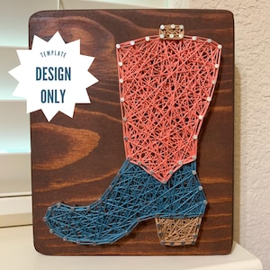 May include: A string art piece featuring a cowboy boot design. The boot is crafted with pink and blue thread on a stained wooden board. The text "TEMPLATE DESIGN ONLY" is in a white starburst shape.