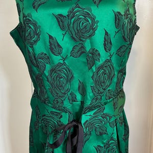 May include: A white ceramic mug with a black handle and the text "But First, Coffee" in a handwritten style. The mug is on a white surface. The mug is approximately 4 inches tall.