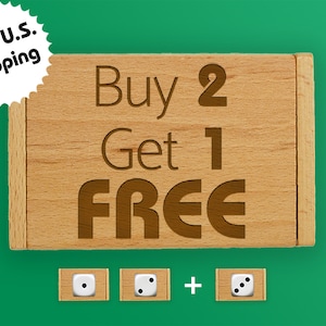 May include: Wooden box with the text "Buy 2 Get 1 FREE" engraved on the front. Three white dice with black dots are shown below the box.
