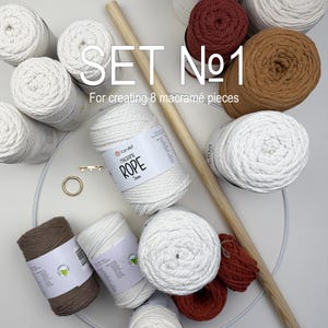 May include: A macramé craft set with white, brown, and rust-colored yarn, wooden dowels, and a metal ring. The set includes multiple spools of rope and the text "SET No 1" and "For creating 8 macramé pieces".