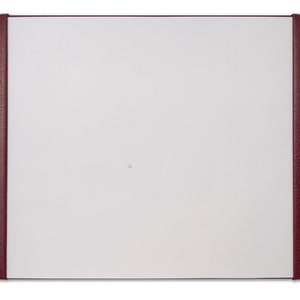 May include: A burgundy leather desk pad with a white writing surface.