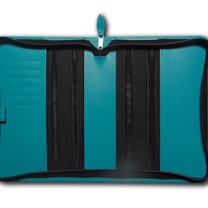May include: Teal leather zippered binder with black interior and multiple card slots.