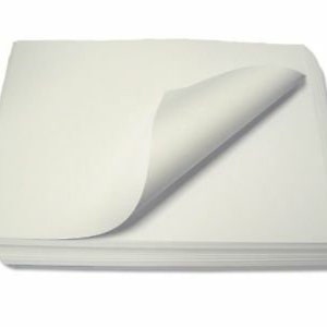 May include: A pile of off-white paper with a single corner of a top sheet curled upwards. The paper has a slight cream hue. The stack is rectangular and rests on a white background.