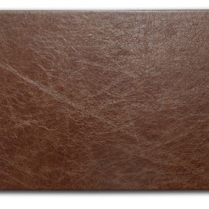 May include: A brown leather texture with a slightly grainy surface.