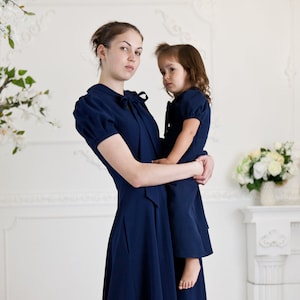 Navy blue mother daughter matching dresses. Chic mommy and me outfits with bow and pockets. Family look formal clothing image 1