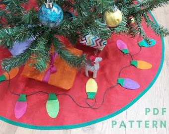 May include: A red felt Christmas tree skirt with a green trim and a string of colorful felt light bulbs. The skirt is decorated with a few presents and a small toy reindeer.
