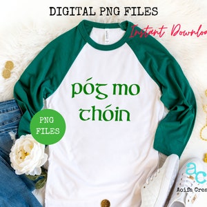 May include: White and green raglan shirt with the text "póg mo chóin" in green. The shirt has green sleeves and a white body. The words "Digital PNG Files" and "Instant Download" are also visible.