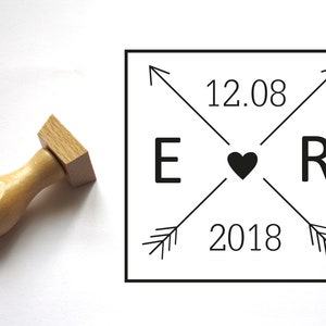 May include: A black and white rubber stamp with the text "E ♥ R 12.08 2018" inside a square frame.