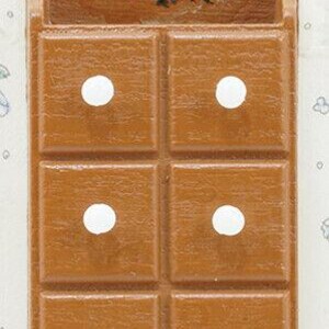 May include: A small, brown, wooden wall-mounted cabinet with six square drawers and white dot handles. The top of the cabinet features a decorative floral design with a red rose and green leaves. The cabinet is likely for small items.