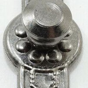 May include: A silver-colored metal decorative pull with a knob in the center. The pull has an ornate design with a loop at the top and bottom for attachment. The central knob is surrounded by a circular plate with decorative details.