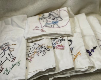 Cow themed embroidered tea towels for 7 days of the week