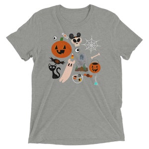 K&ouml;nnte beinhalten: Hellgraues T-Shirt mit einem Halloween-Motiv. Das Design zeigt einen K&uuml;rbis, eine schwarze Katze, einen Geist, S&uuml;&szlig;igkeiten, ein Spinnennetz, einen Totenkopf und einen Grabstein. Das T-Shirt besteht aus einem weichen, bequemen Material.