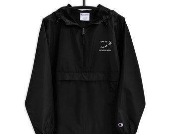 May include: Black Champion brand windbreaker jacket with a zip closure and a hood. The jacket has an embroidered design on the front that says "Off to Neverland" with a silhouette of Peter Pan flying.