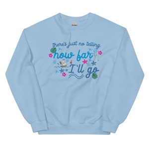 May include: Light blue sweatshirt with the text "there's just no telling how far I'll go" in a whimsical font. The design includes tropical elements like palm leaves, starfish, and a sailboat, creating a vacation theme.