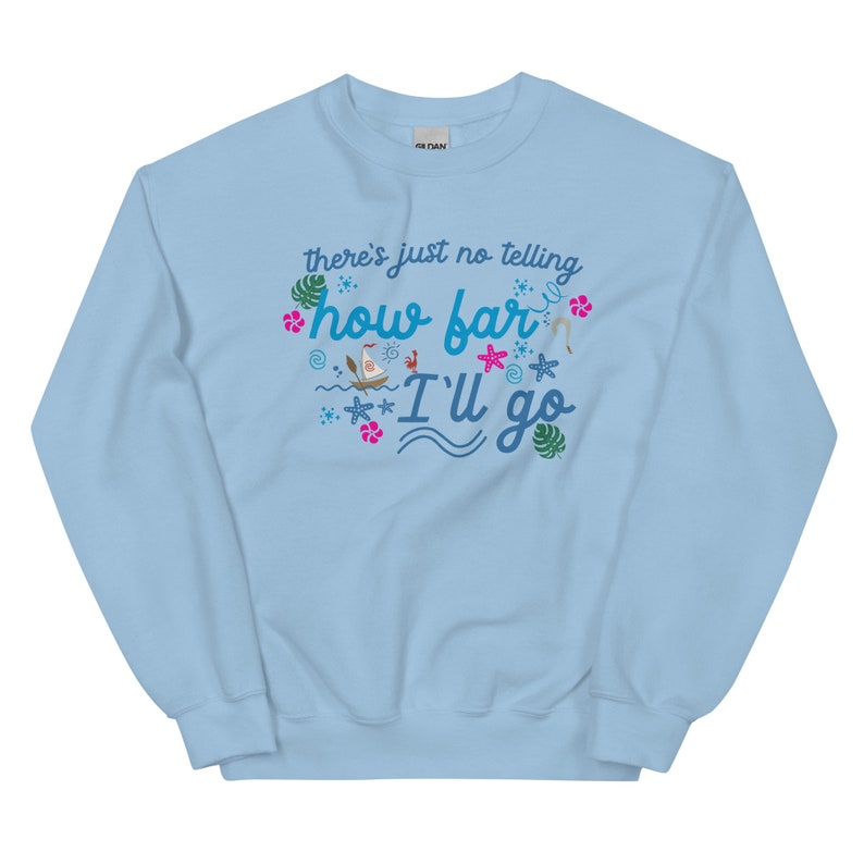 May include: Light blue sweatshirt with the text "there's just no telling how far I'll go" in a whimsical font. The design includes tropical elements like palm leaves, starfish, and a sailboat, creating a vacation theme.