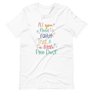 May include: White t-shirt with a colorful graphic that says "ALL you* Need is faith* Trust, & a little Pixie Dust".