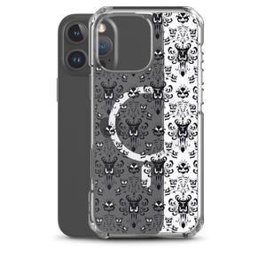 May include: A clear phone case with a black and white pattern. The design features a repeating pattern of stylized haunted house elements. The phone case is shown on a dark grey phone.