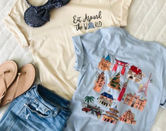 May include: A light blue t-shirt with colorful illustrations of world landmarks, a cream-colored t-shirt with the text "Eat Around The World", denim shorts, sandals, and a sequined mouse ear headband.