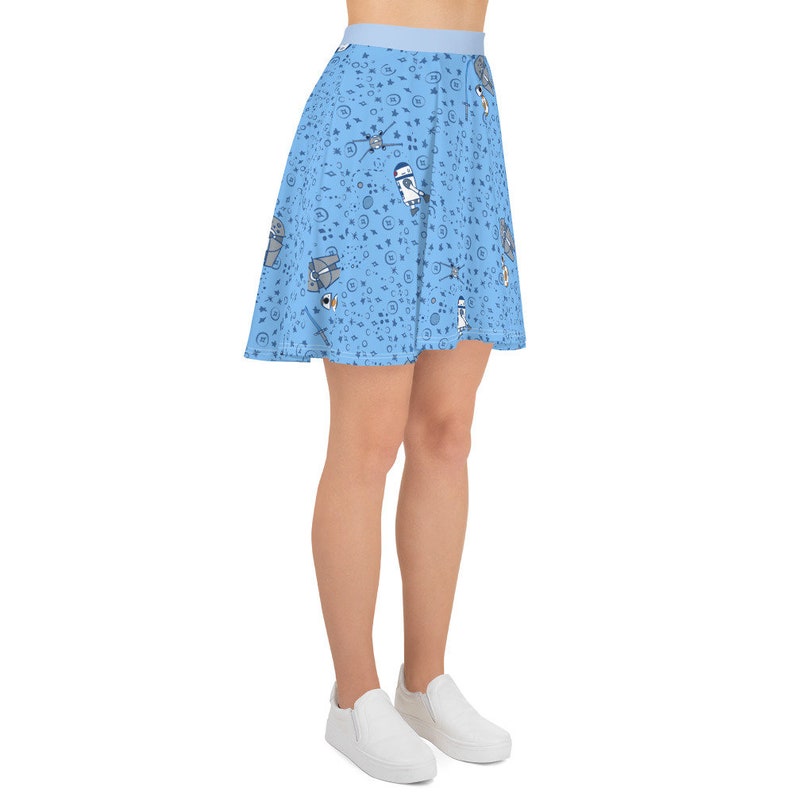 Puede incluir: Una falda skater azul claro con un patr&oacute;n de naves espaciales, planetas y estrellas. La falda est&aacute; hecha de una tela suave y c&oacute;moda y tiene una cintura el&aacute;stica.