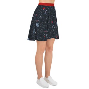 May include: A black skater skirt with a red waistband and a space-themed print featuring stars, planets, and spaceships.