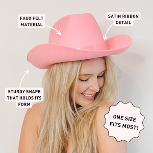 May include: A pink felt cowboy hat with a satin ribbon detail. The hat has a sturdy shape that holds its form. One size fits most.