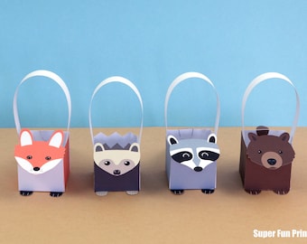 May include: Four small paper gift bags with animal faces. The bags are white with a light blue, gray, or brown background. The animals are a fox, a hedgehog, a raccoon, and a bear. The bags have white handles.