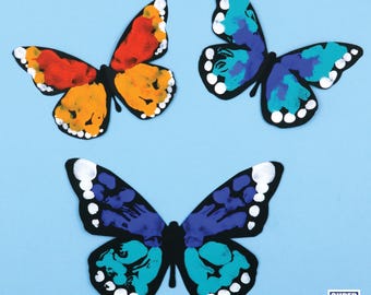May include: Three colorful butterfly shapes with white dots, painted in shades of blue, orange, and red. The butterflies are on a light blue background.