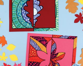 May include: Two rectangular paper cards featuring intricate leaf-themed artwork. The top card displays a dark red oak leaf silhouette against a green and blue patterned background. The bottom card shows a pink maple leaf design with geometric patterns.