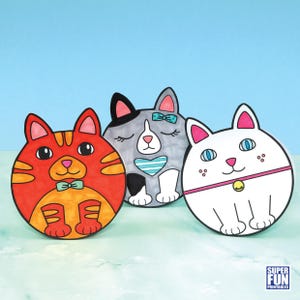 May include: Three cartoon cat illustrations in a row. One is orange with a bow tie, another is grey with a blue bow, and the third is white with a pink collar. The background is light blue.