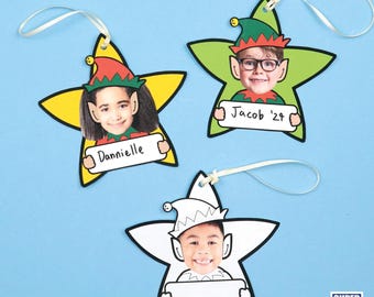 May include: Three printable Christmas ornaments shaped like stars with elf hats and faces. The ornaments have a space for a photo and a name. The text on the ornaments reads "Danielle", "Jacob '27", and a blank space.
