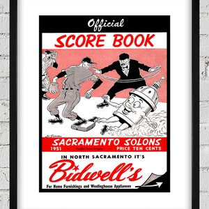 May include: A vintage black and red scorebook for the Sacramento Solons baseball team. The cover features a cartoon illustration of a baseball player sliding into home plate. The text "Official Score Book" is printed in red letters on a black background. The text "Sacramento Solons" is printed in black letters on a red background. The text "Price Ten Cents" is printed in black letters on a red background. The text "In North Sacramento It's Bidwell's" is printed in red letters on a black background. The text "For Home Furnishings and Westinghouse Appliances" is printed in black letters on a white background.