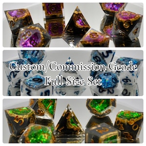 May include: A set of custom, full-size, geode dice. The dice are made of clear resin with gold and silver glitter embedded in the resin. The dice are in various colours, including blue, green, and purple. The dice are labelled with numbers 1 through 6.