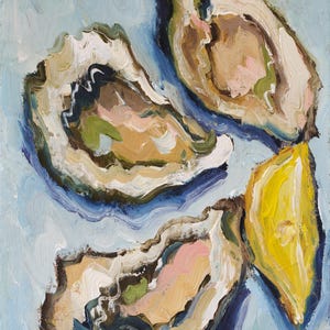 May include: An oil painting featuring three open oysters and a bright yellow lemon wedge. The oysters display textured brushstrokes in shades of beige, white, pink, and dark green against a light blue background. The artist's signature is in the corner.