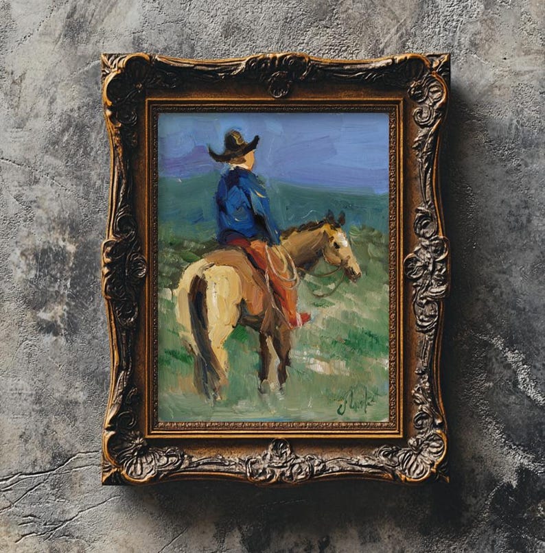 May include: An oil painting in a dark, ornate, carved gold frame depicting a rider in a blue jacket and dark hat mounted on a light brown horse. The scene features a green landscape under a blue sky, with a signature visible in the bottom right corner.