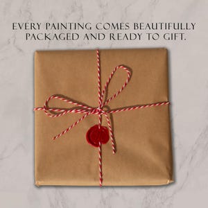 May include: A square package wrapped in brown paper, tied with red and white baker's twine, and sealed with a red wax stamp. The text above reads: EVERY PAINTING COMES BEAUTIFULLY PACKAGED AND READY TO GIFT.