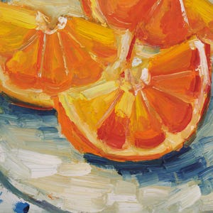 Original oil painting of juicy orange slices, elegantly presented in a frame. The artwork is captured in a vibrant impressionist style with bold, thick brushstrokes that highlight the glistening texture of the fruit. Featuring a bright citrus palette and a beautiful play of light, this small fruit still life is a perfect pop of color for a modern kitchen or a sunny dining room wall.