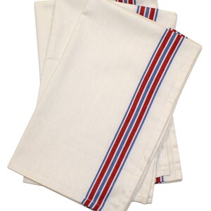 May include: A stack of three white kitchen towels with red and blue stripes along the edge.