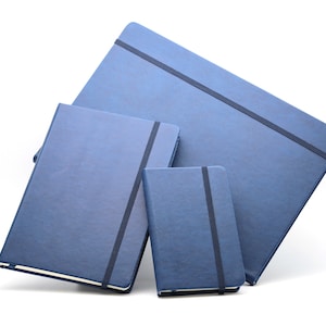 May include: Three blue notebooks of different sizes, each with a black elastic band closure. The notebooks are stacked on top of each other.