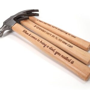 May include: A white ceramic mug with a black handle and the text "But First, Coffee" in a black, bold font. The mug is on a wooden surface. The mug is approximately 10 cm tall.