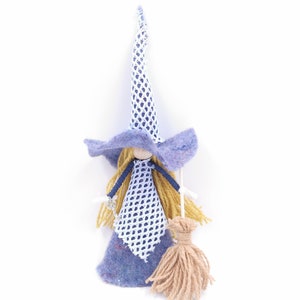 May include: A handmade felt witch doll with a blue and white patterned hat, a blue and white patterned dress, and a brown broom.