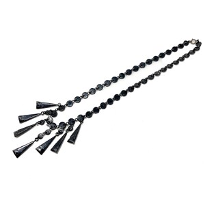 May include: A black necklace with a chain of round metal links and a dangling fringe of triangular metal pieces.