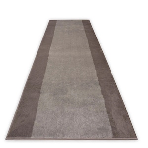 May include: A long, rectangular runner rug with a light gray center and two dark gray stripes along the edges.