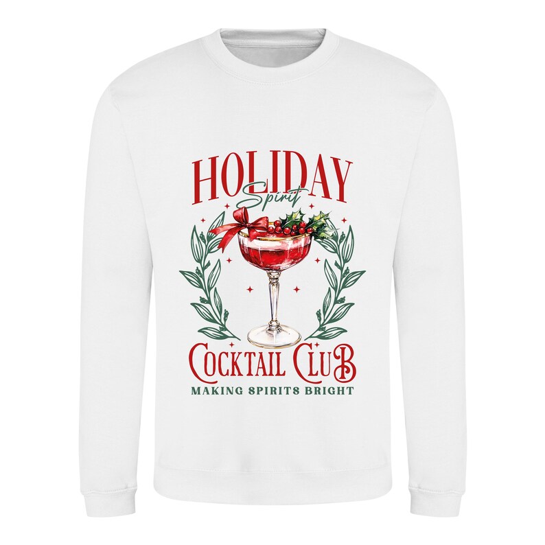 May include: White sweatshirt with a festive cocktail graphic. The design features a red cocktail with a bow, holly, and the words "HOLIDAY Spirit" and "COCKTAIL CLUB" in red, with green accents. The text "MAKING SPIRITS BRIGHT" is also included.